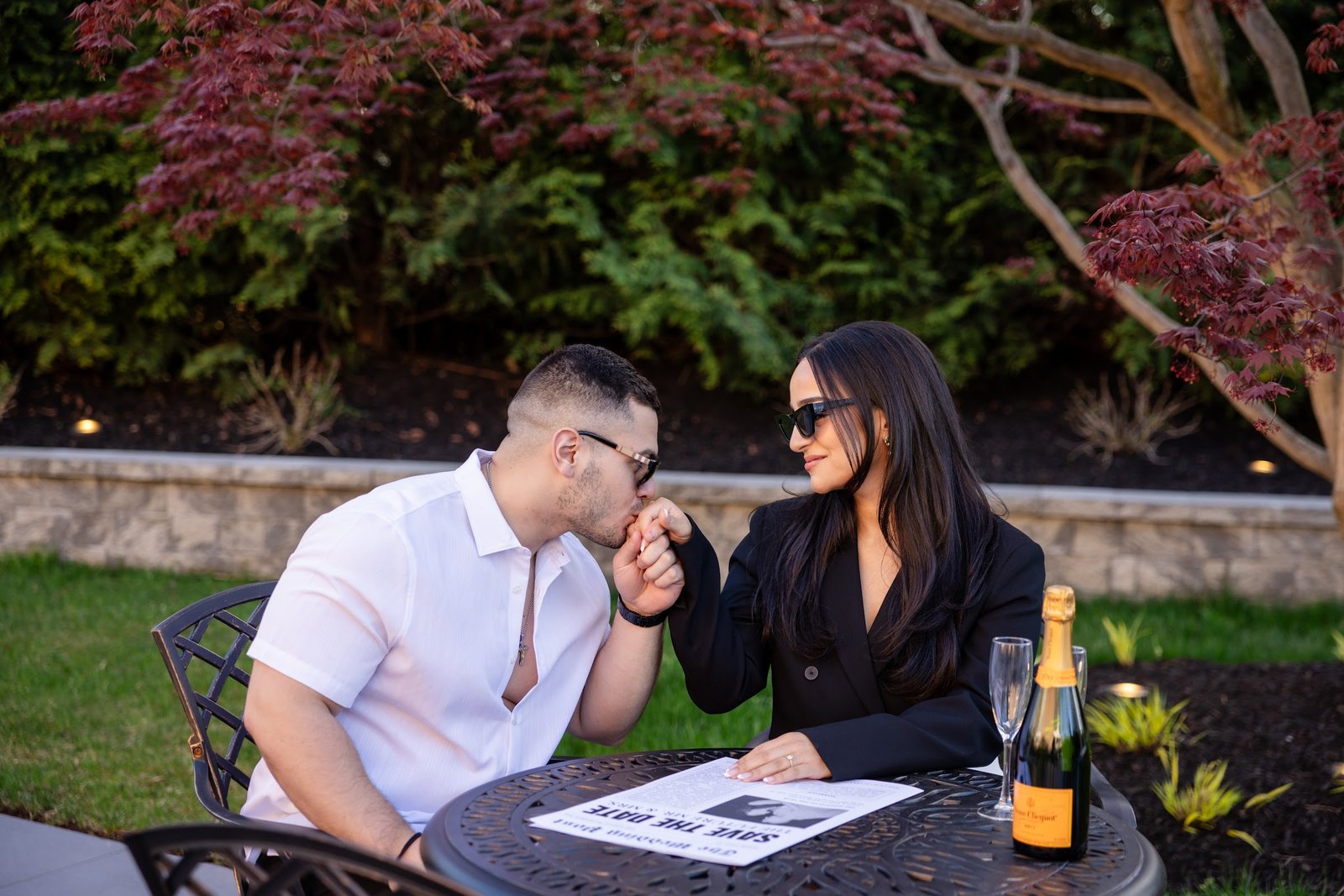 Couple seated together at an outdoor cafe table
