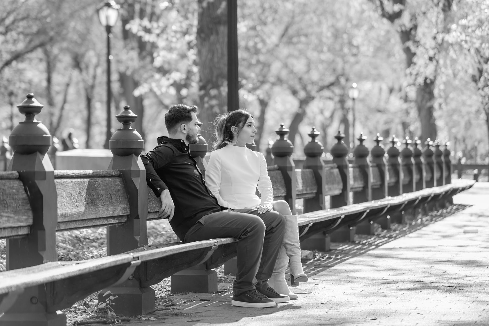 Black and white portrait of the couple seated on a park bench