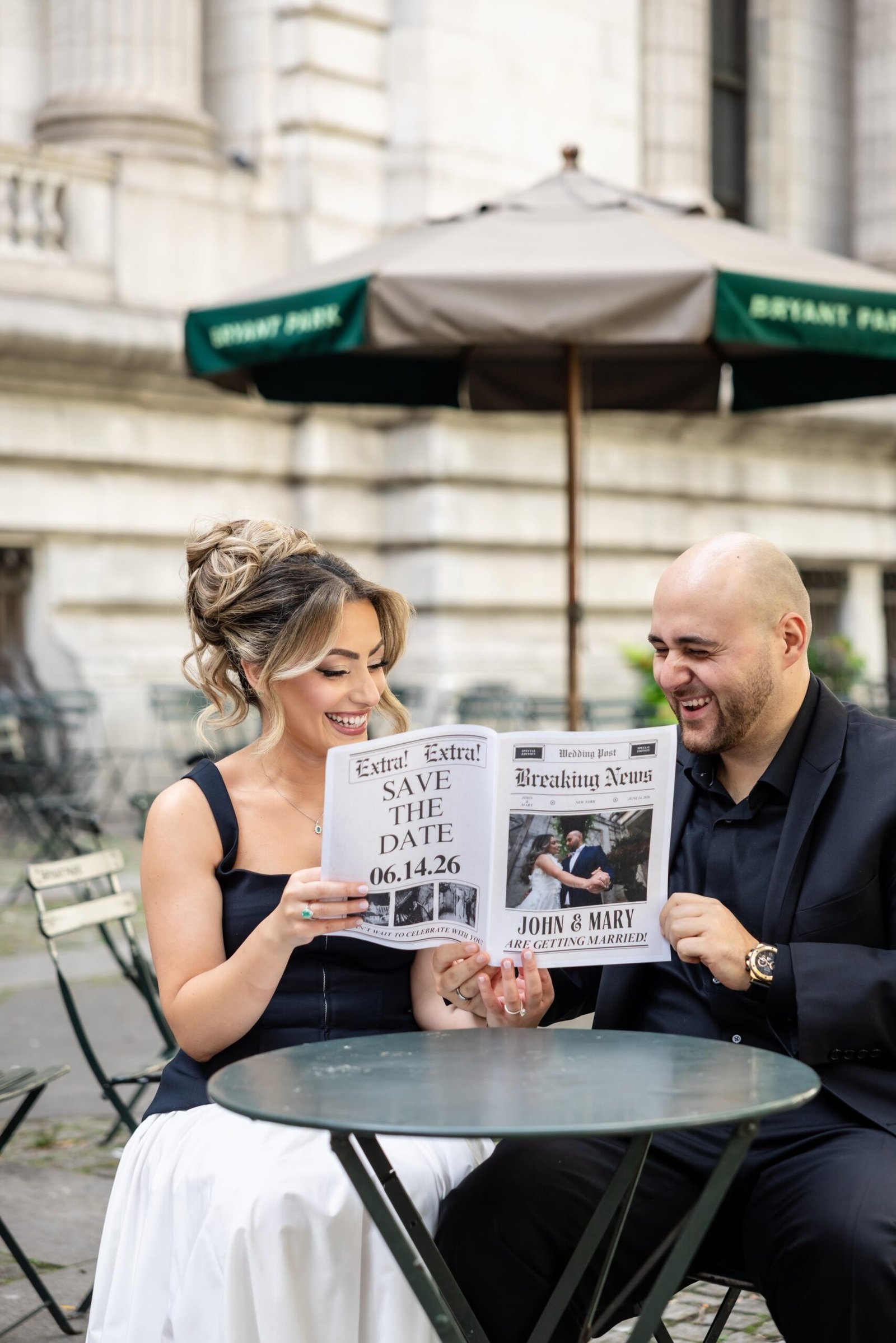 Couple reading their wedding announcement newspaper in the park
