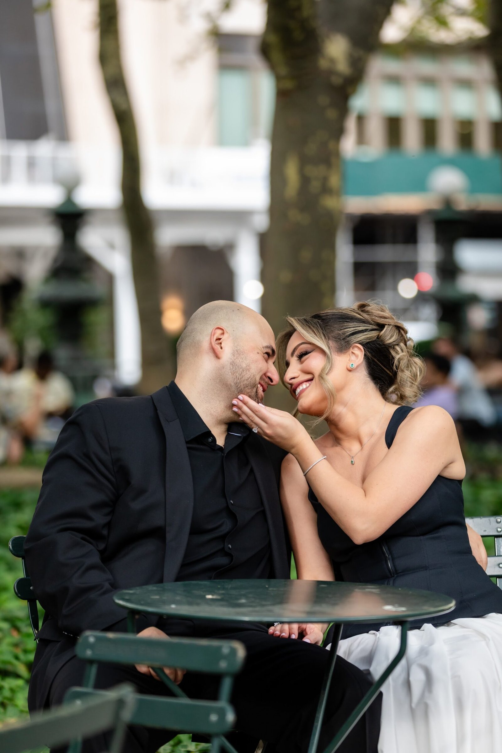 Couple laughing together at a park cafe table