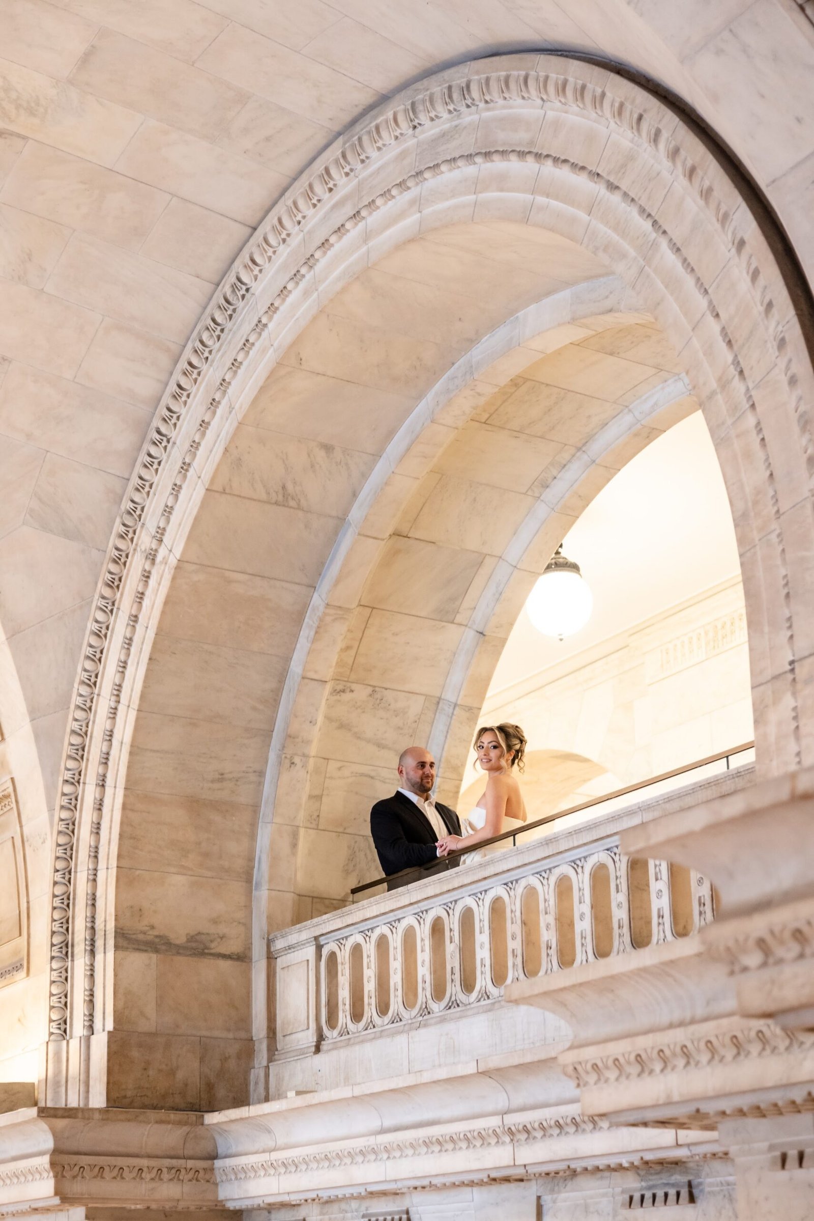 Couple standing together on the library landing