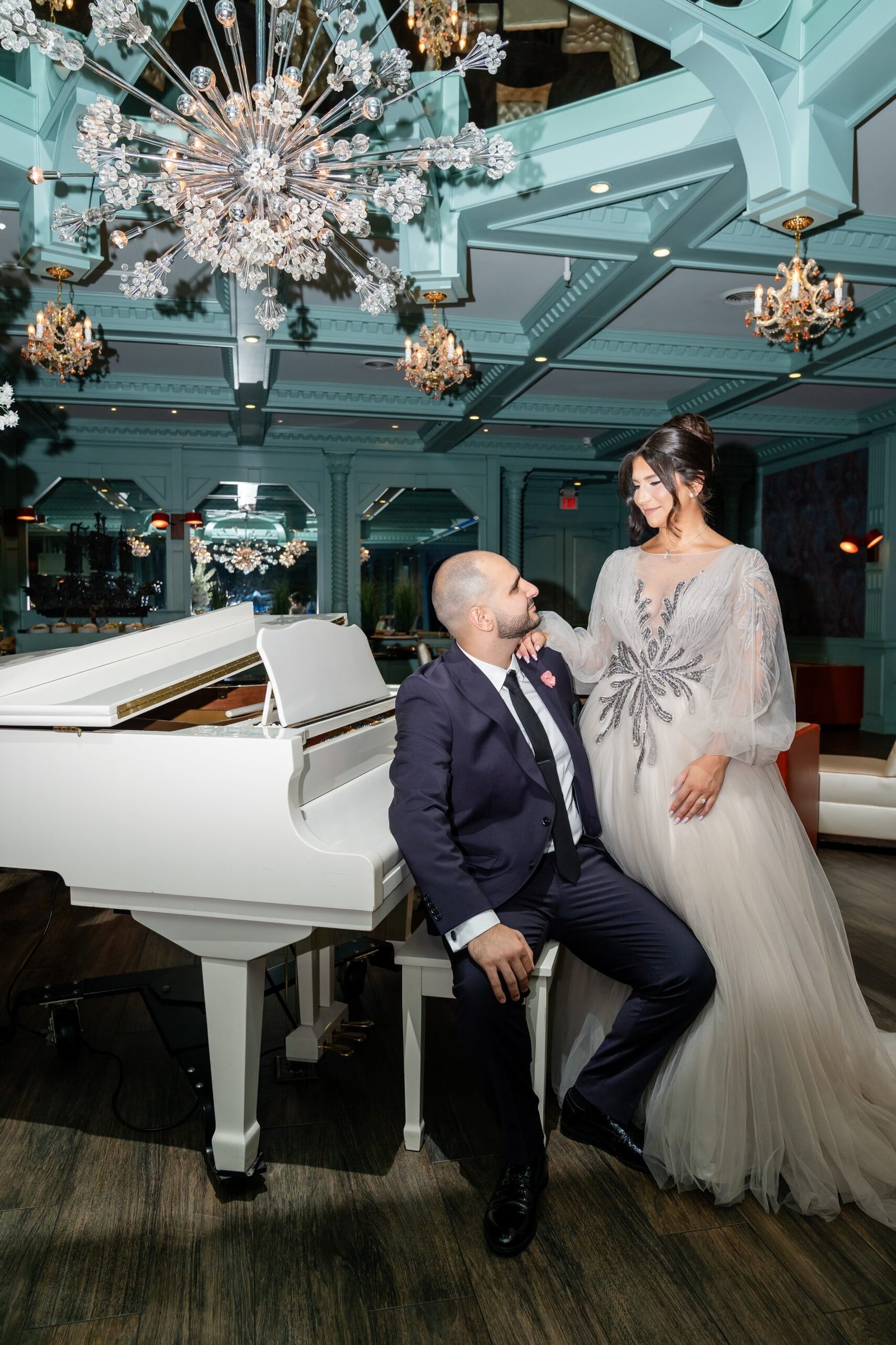 Couple beside a white grand piano