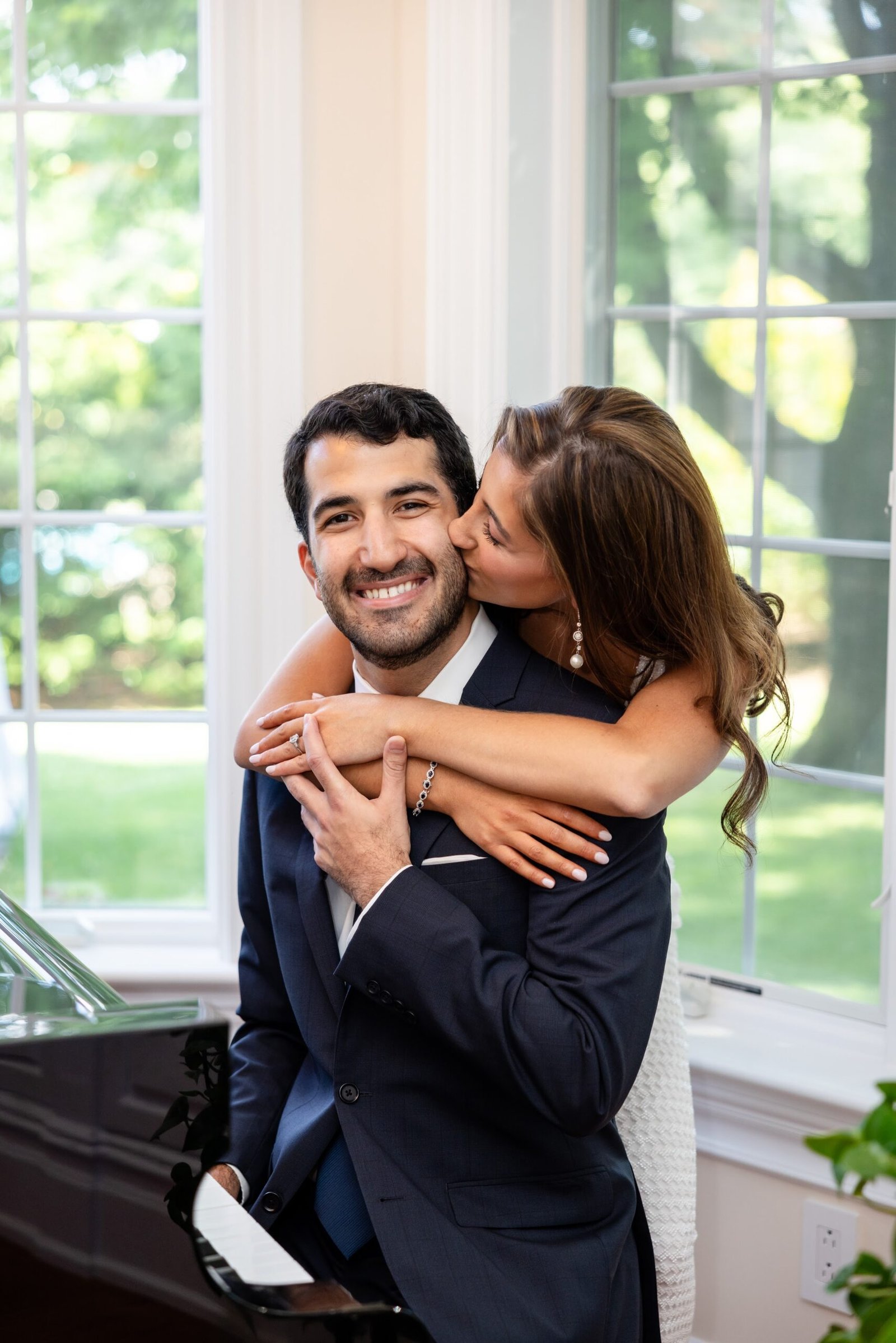 Couple embracing beside a window