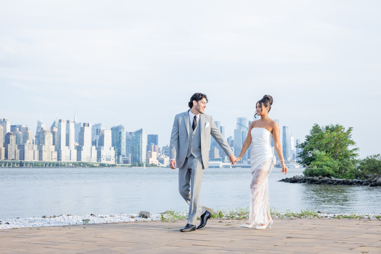 Couple walking together with the city skyline behind them