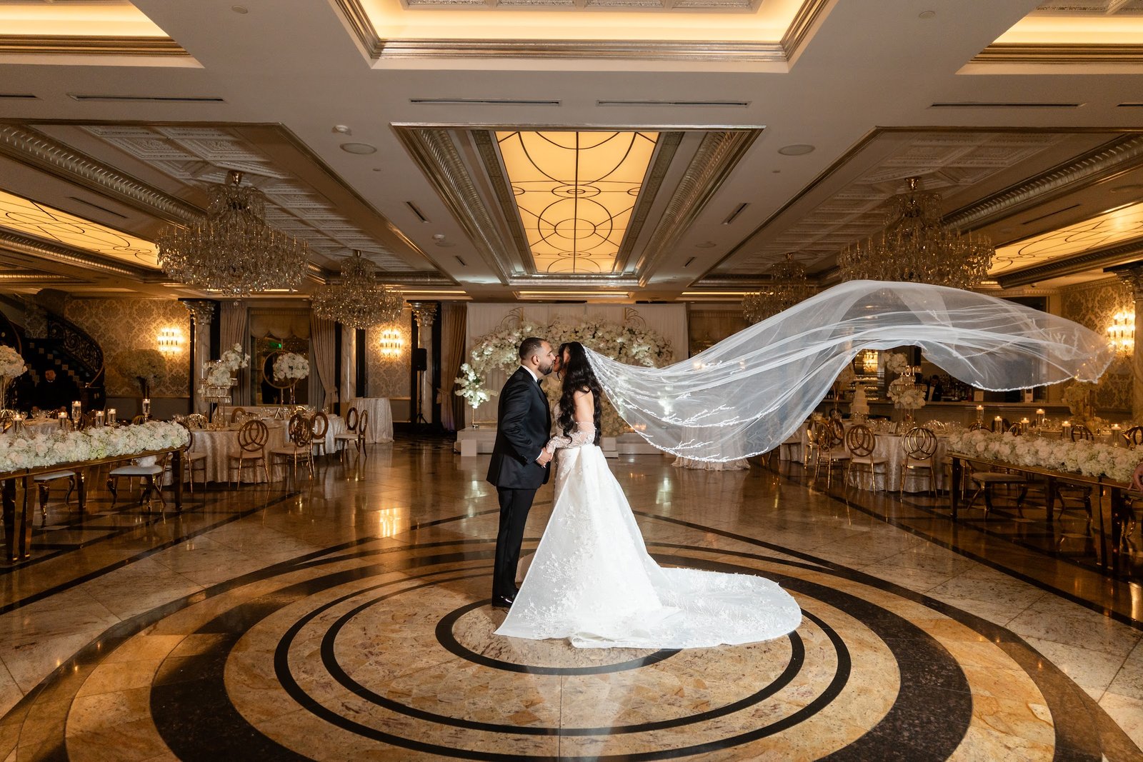 Bride with a flowing veil in a ballroom, photographed by Team Zoom Studio