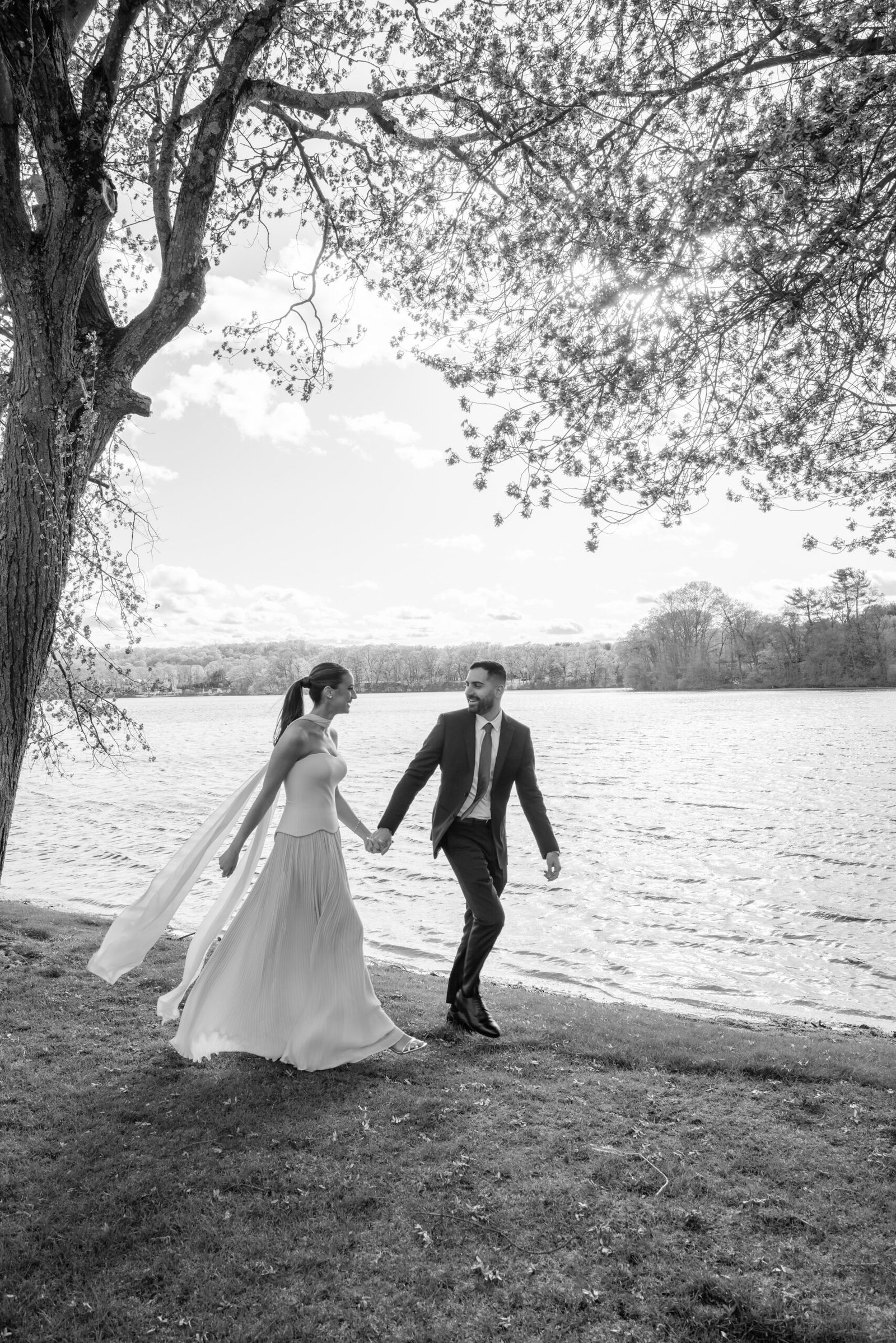 Black and white photograph of the couple walking by the lake