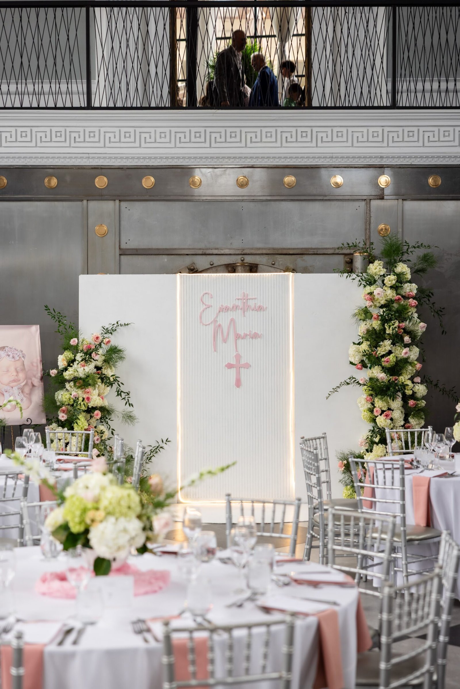 Christening backdrop with florals and a cross