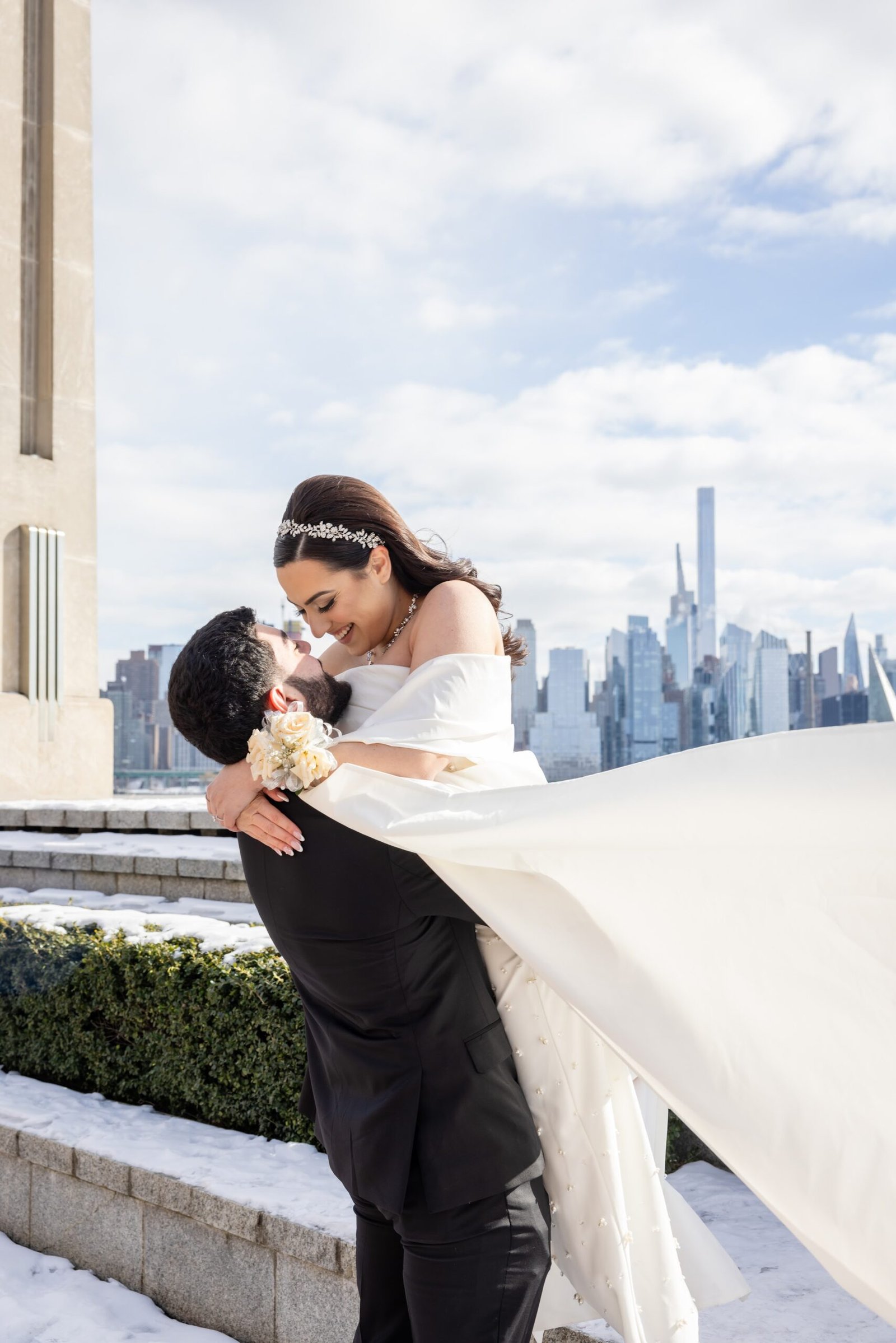 Engaged couple photographed against the Manhattan skyline