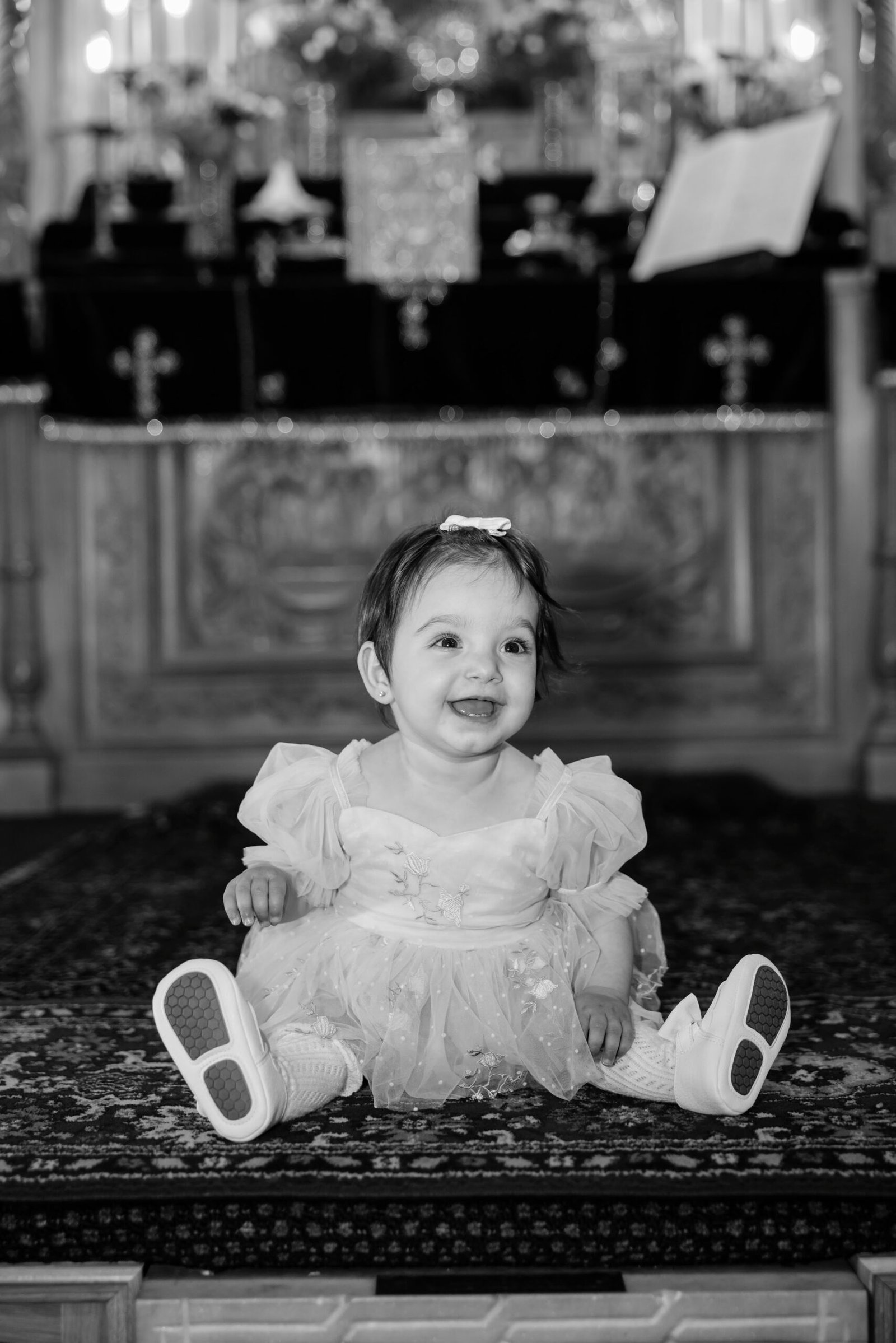 Black and white photograph of a little girl in the church