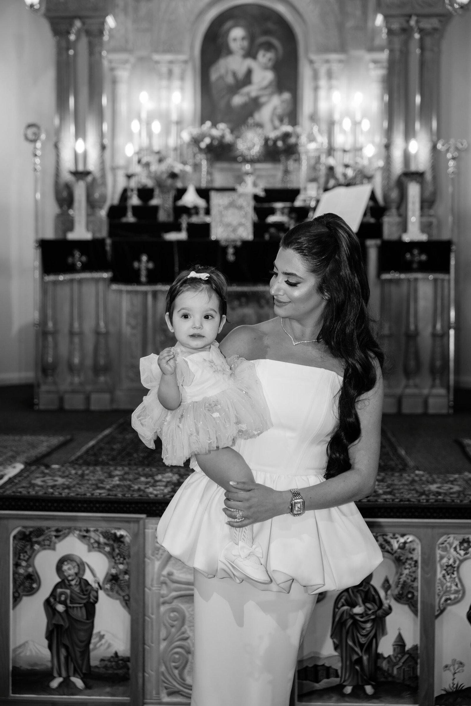 Black and white photograph of a girl in white inside the church