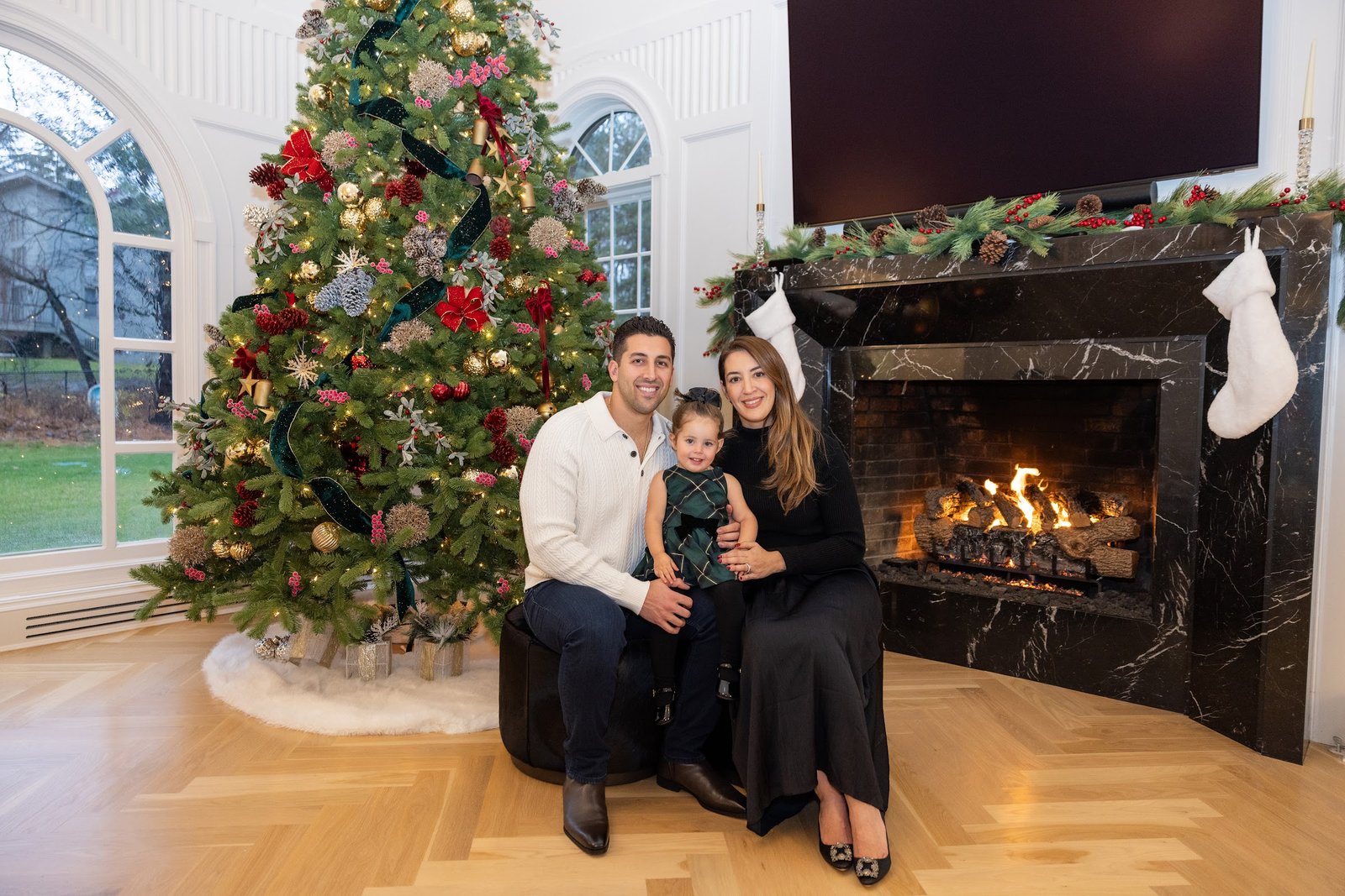 Family photographed together by the fireplace