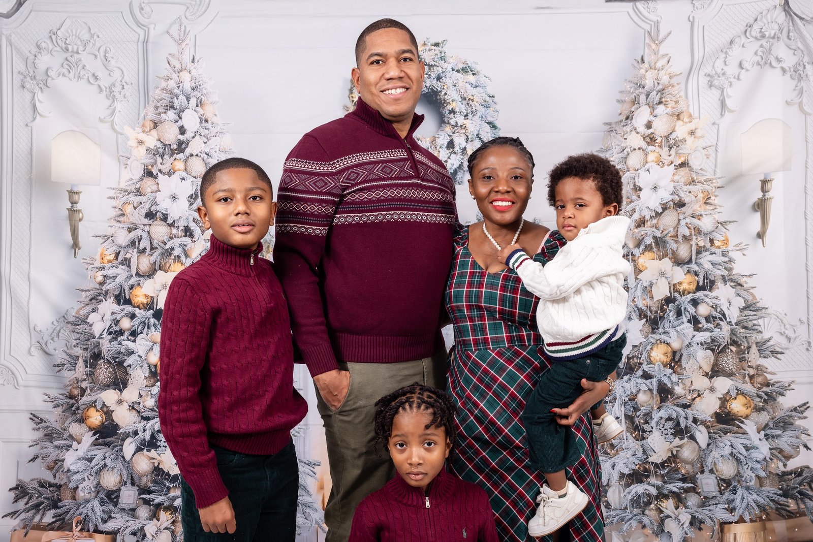 Family portrait in front of the festive backdrop