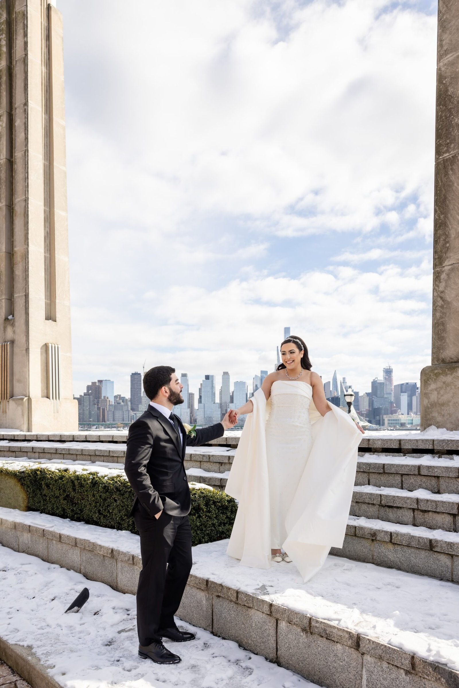 Couple posing on a rooftop with the Manhattan skyline behind them
