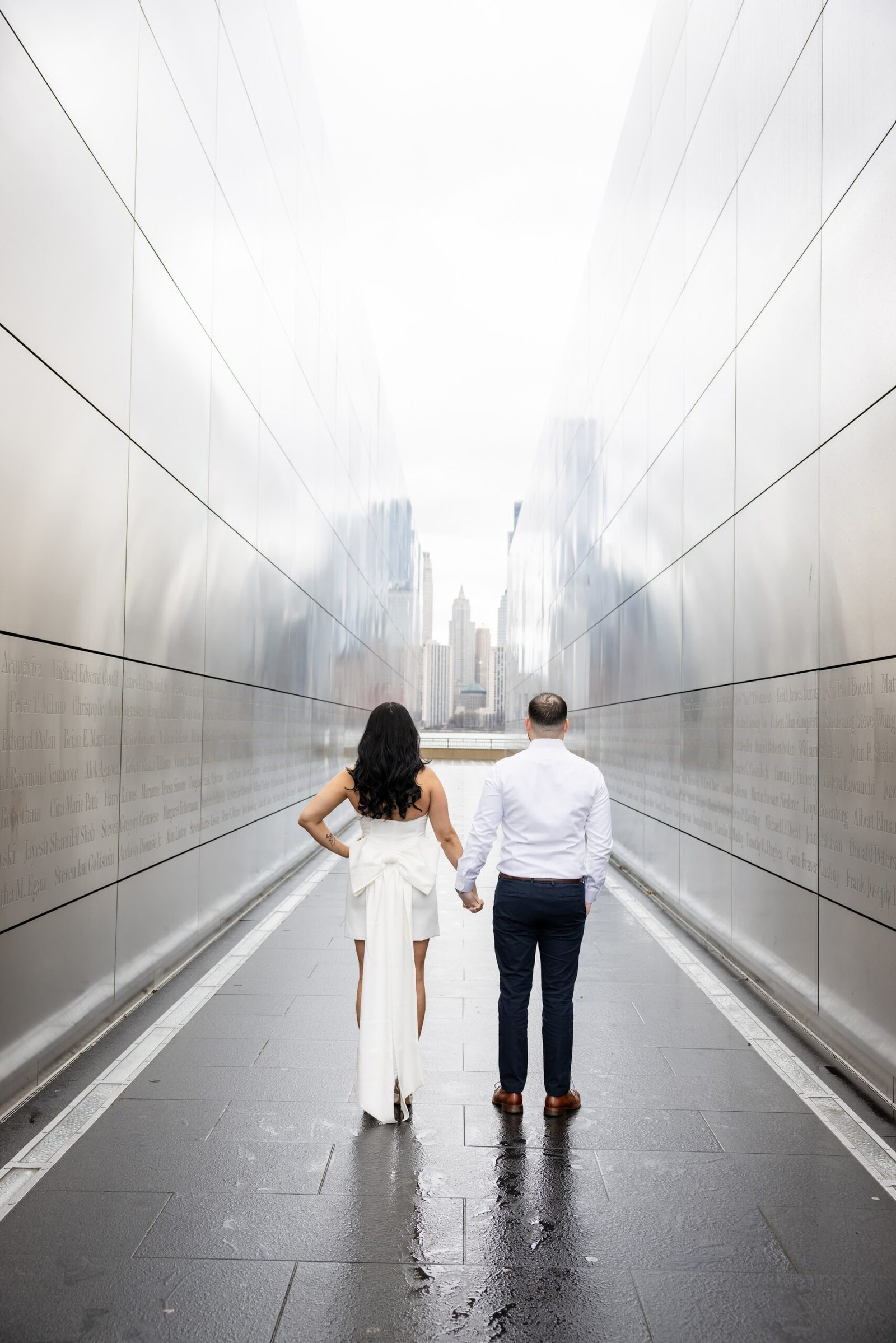 Couple walking hand in hand through the Empty Sky Memorial