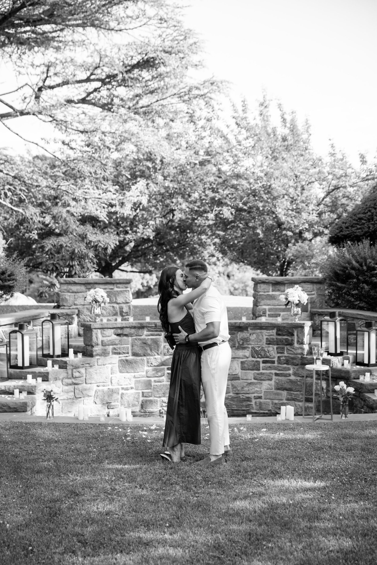 Black and white photograph of the couple embracing in the garden