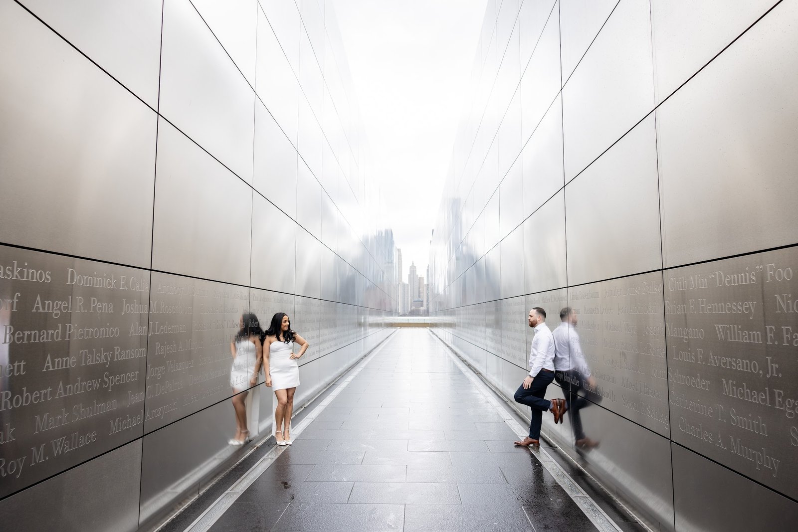 Couple framed by the long corridor of the Empty Sky Memorial