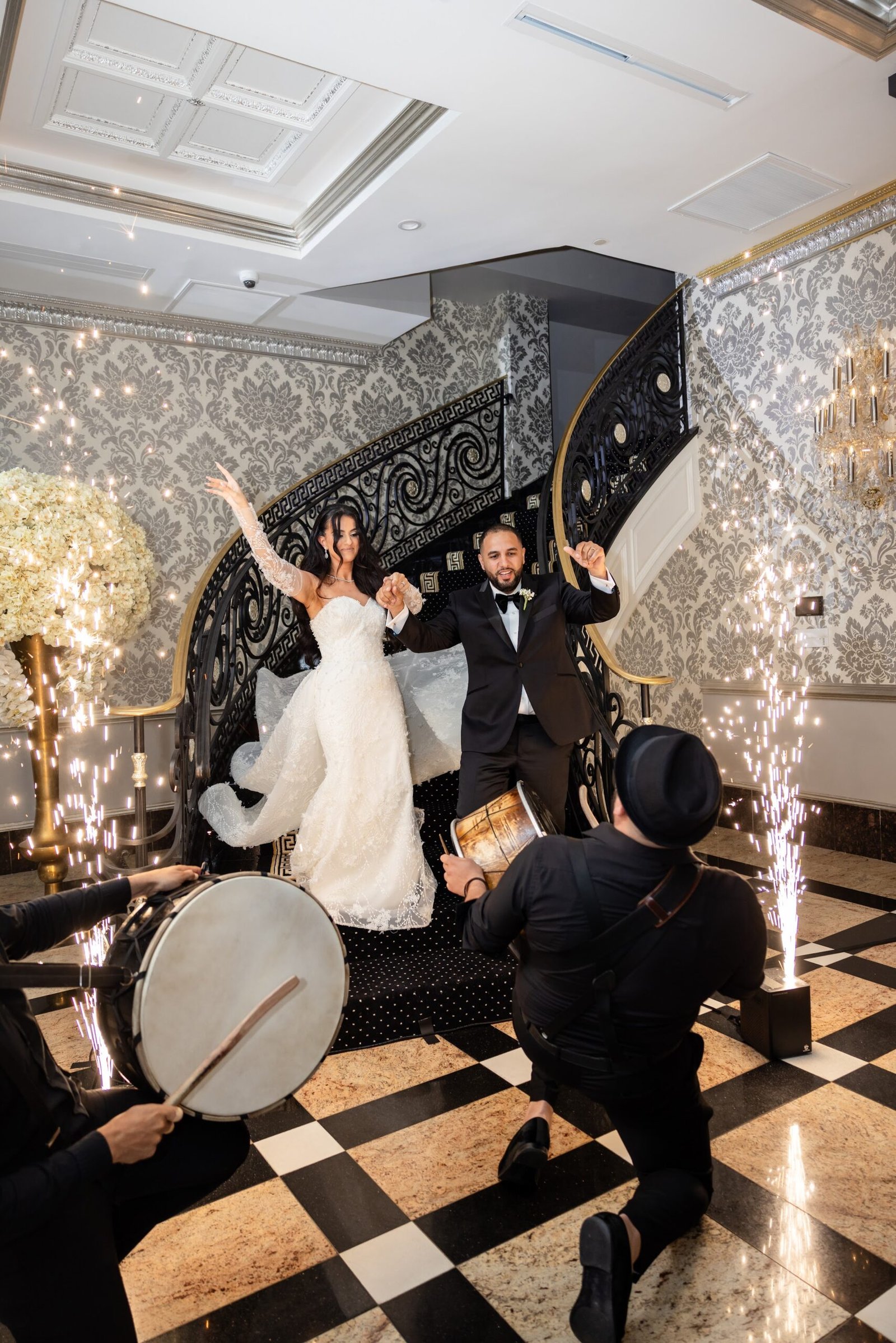 Bride and groom making their entrance with sparklers and a drummer